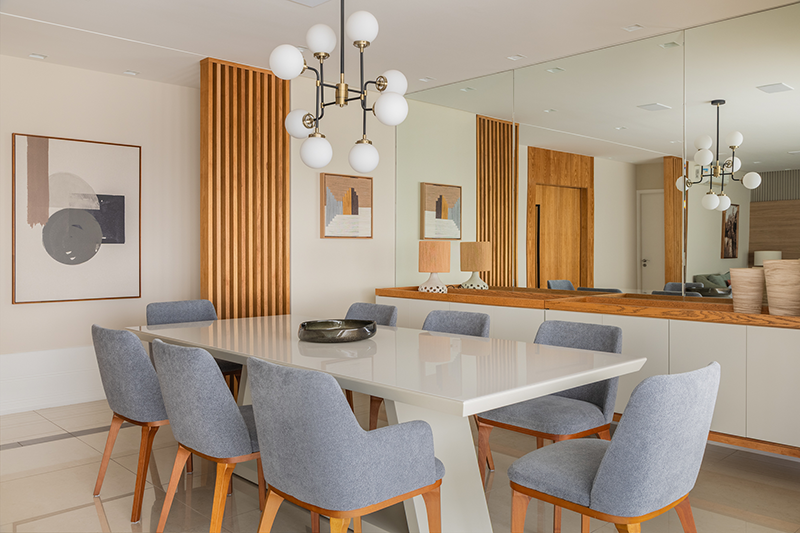 Projeto: Stal Arquitetura | A nova porta social, em lâmina de freijó, é emoldurada por painéis simétricos que garantem continuidade estética ao ambiente.