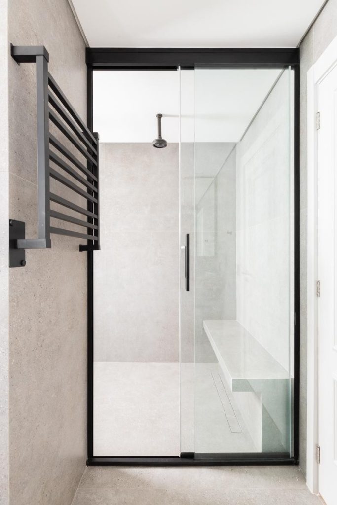 Projeto: Sabrina Salles | Atmosfera de spa, luz suave e detalhes sofisticados — o banheiro da suíte combina elegância e atemporalidade